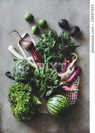 Healthy grocery goods in net bag over concrete Healthy grocery goods in net bag over concrete 58845924