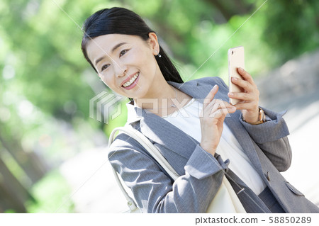 Business woman with smartphone Business woman with smartphone 58850289