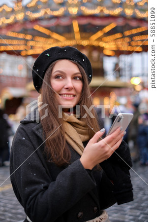 young attractive girl uses a phone on the street, young attractive girl uses a phone on the street, 58851099