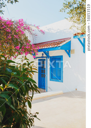 Traditional white greek house with blue windows 58853519