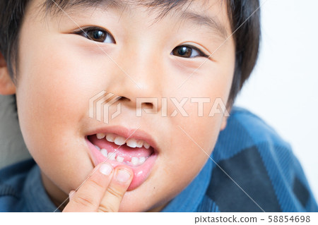 A boy with a tooth missing A boy with a tooth missing 58854698
