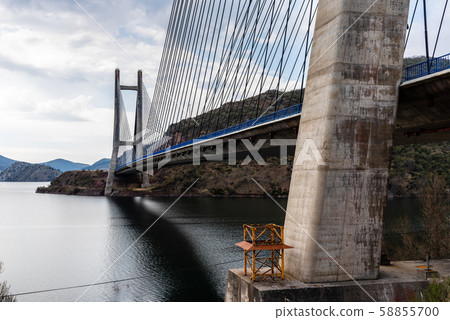 Modern suspension bridge across reservoir Los Barrios de Luna Modern suspension bridge across reservoir Los Barrios de Luna 58855700