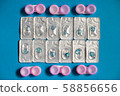 Color contact lenses in blisters and contact lens cases on blue background 58856656