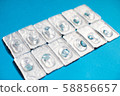 Blue color contact lenses in blisters on blue background 58856657