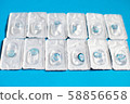 Blue color contact lenses in blisters on blue background 58856658