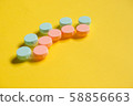 Pink blue contact lens cases on yellow background 58856663