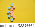 Pink blue contact lens cases on yellow background 58856664