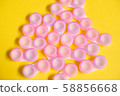 Pink contact lens cases on yellow background 58856668