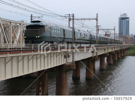 Luxury train Twilight Express Ruifu passes the iron bridge across the Yodo River 58857929