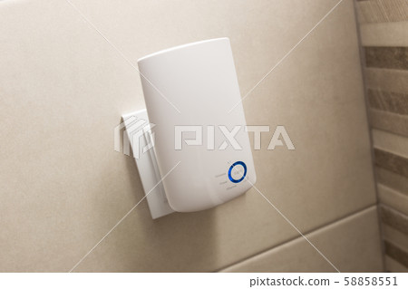 Wifi home repeater plugged in closeup. 58858551