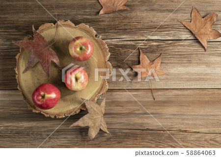 ripe red apples on a wooden cutting boad on table 58864063