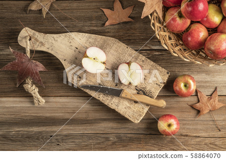 sliced apples on a wooden cutting board on a table sliced apples on a wooden cutting board on a table 58864070