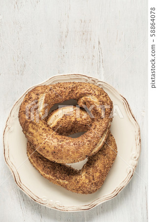 crispy Turkish bagel, simit on a wooden table crispy Turkish bagel, simit on a wooden table 58864078