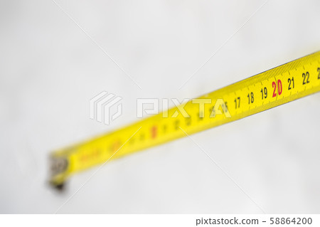 Yellow measuring tape with size 20 on white.  58864200