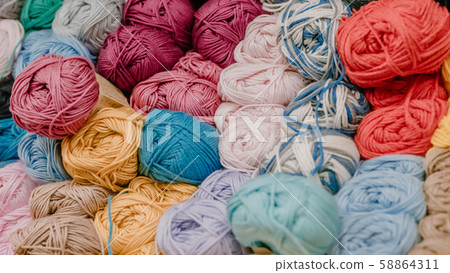 Different colored yarn balls in the shop. 58864311