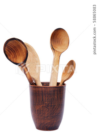 Used wooden spoons in clay mug isolated on white Used wooden spoons in clay mug isolated on white 58865083