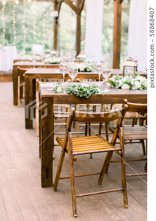 Wedding tables in restaurant outdoors. Banquet. The chairs and table for guests, decorated with 58868407