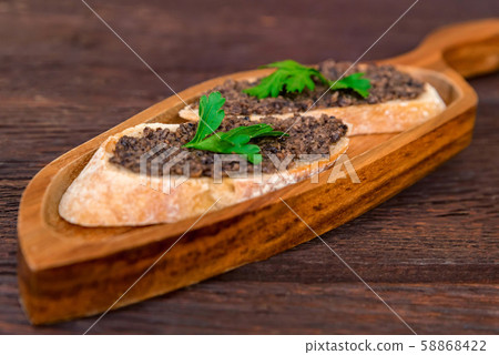 Fresh tasty bruschetta with truffle sauce and parsley Fresh tasty bruschetta with truffle sauce and parsley 58868422