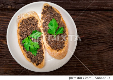 Fresh tasty bruschetta with truffle sauce and parsley. Top view Fresh tasty bruschetta with truffle sauce and parsley. Top view 58868423