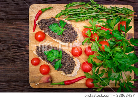 Fresh tasty bruschetta with truffle sauce, chili, parsley and tomates. Top view Fresh tasty bruschetta with truffle sauce, chili, parsley and tomates. Top view 58868457