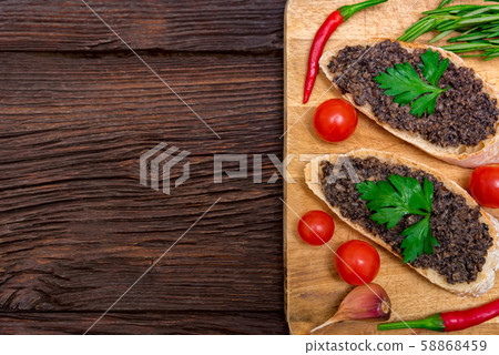 Fresh tasty bruschetta with truffle sauce, chili, parsley and tomates. Top view Fresh tasty bruschetta with truffle sauce, chili, parsley and tomates. Top view 58868459