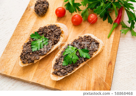 Fresh tasty bruschetta with truffle sauce, parsley and tomates. Top view Fresh tasty bruschetta with truffle sauce, parsley and tomates. Top view 58868468
