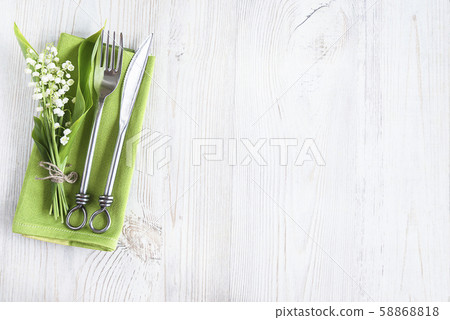 Romantic place setting with bouquet of lilies of the valley 58868818