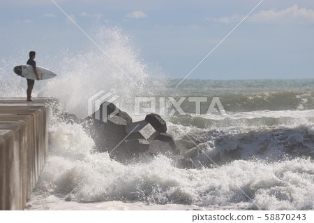 Surfer jumping from the embankment Surfer jumping from the embankment 58870243