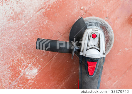 Top view of electric angle grinder on a wooden Top view of electric angle grinder on a wooden 58870743