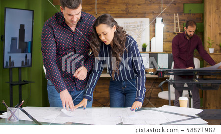 Team of architects in modern office working Team of architects in modern office working 58871982