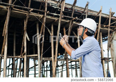 Male architect inspecting building house 58872066