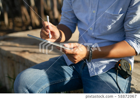 Male architect inspecting building house Male architect inspecting building house 58872067