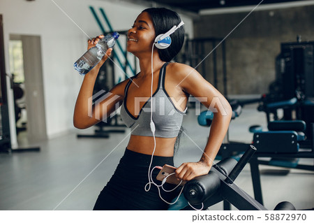 A beautiful black girl is engaged in a gym 58872970