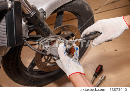 The process of replacing brake pads on a 58873440