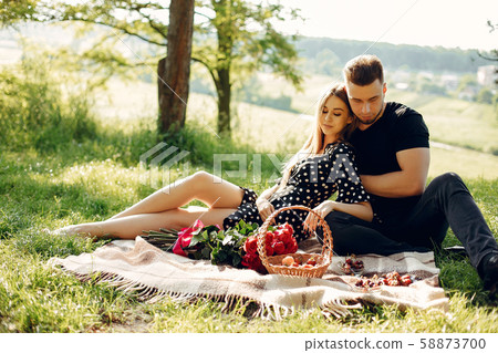 Beautiful couple spend time in a summer field 58873700