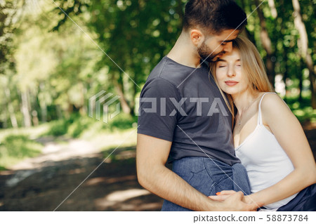 Beautiful couple spend time on a summer forest Beautiful couple spend time on a summer forest 58873784