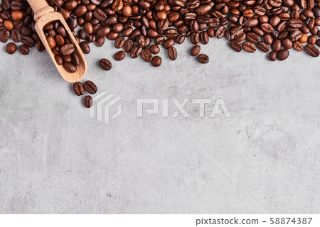 Coffee beans isolated on a grey concrete background. Coffee beans isolated on a grey concrete background. 58874387
