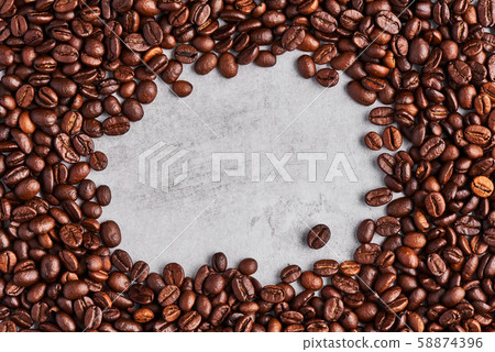 Coffee beans isolated on a grey concrete background. 58874396