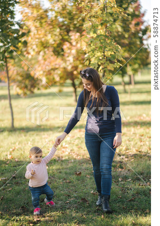 Happy little girl walk with mom in autumn in the park 58874713