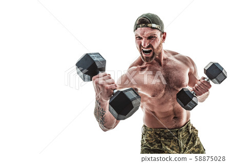 Muscular athlete bodybuilder man in camouflage pants with a naked torso punching with dumbbells like 58875028