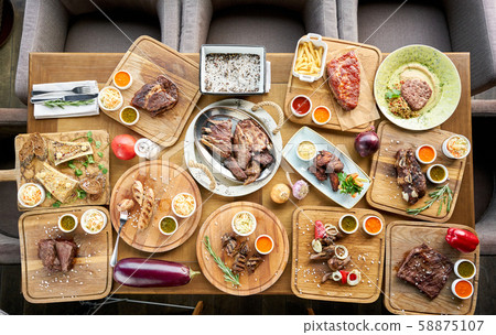 Barbecue restaurant menu. Many different food on the table. Dinner party or Banquet. Top view 58875107
