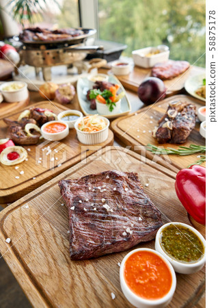 Grilled Skirt Steak. Barbecue restaurant menu. Many different food on the table. Dinner party or Grilled Skirt Steak. Barbecue restaurant menu. Many different food on the table. Dinner party or 58875178