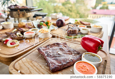 Grilled Skirt Steak. Barbecue restaurant menu. Many different food on the table. Dinner party or Grilled Skirt Steak. Barbecue restaurant menu. Many different food on the table. Dinner party or 58875190