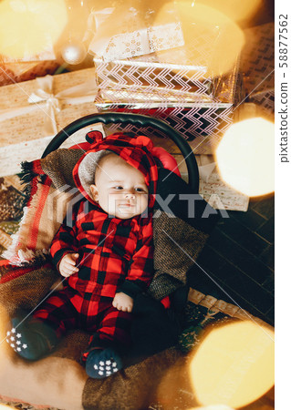 Little girl sitting near christmas trre Little girl sitting near christmas trre 58877562