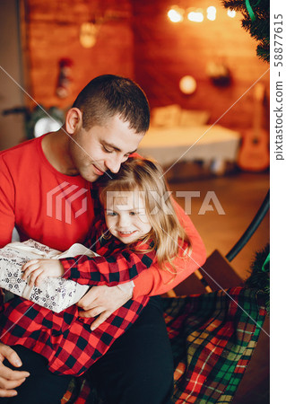 Handsome father sitting at home with little child Handsome father sitting at home with little child 58877615