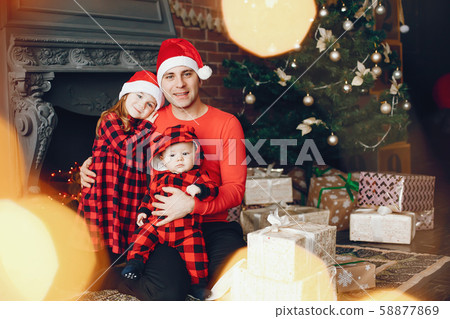 Handsome father sitting at home with little child 58877869