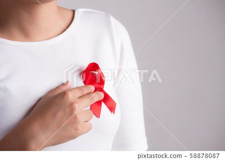 Closeup of red badge ribbon on woman chest 58878087