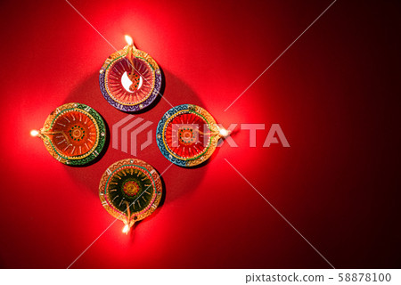 Happy Diwali - Clay Diya lamps lit Hindu festival of lights celebration Happy Diwali - Clay Diya lamps lit Hindu festival of lights celebration 58878100