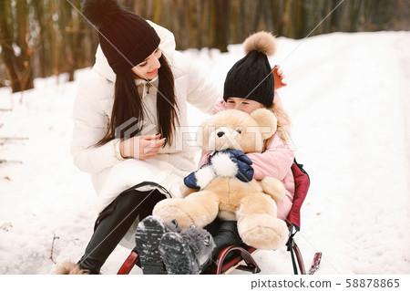 Mother and daughter in a winter park Mother and daughter in a winter park 58878865