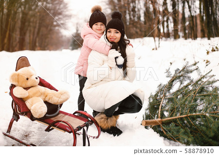 Mother and daughter in a winter park Mother and daughter in a winter park 58878910